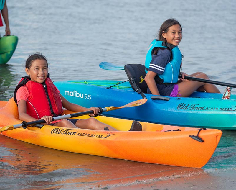 Kids in Old Town Ocean Kayaks wearing Inlet Jr life jackets