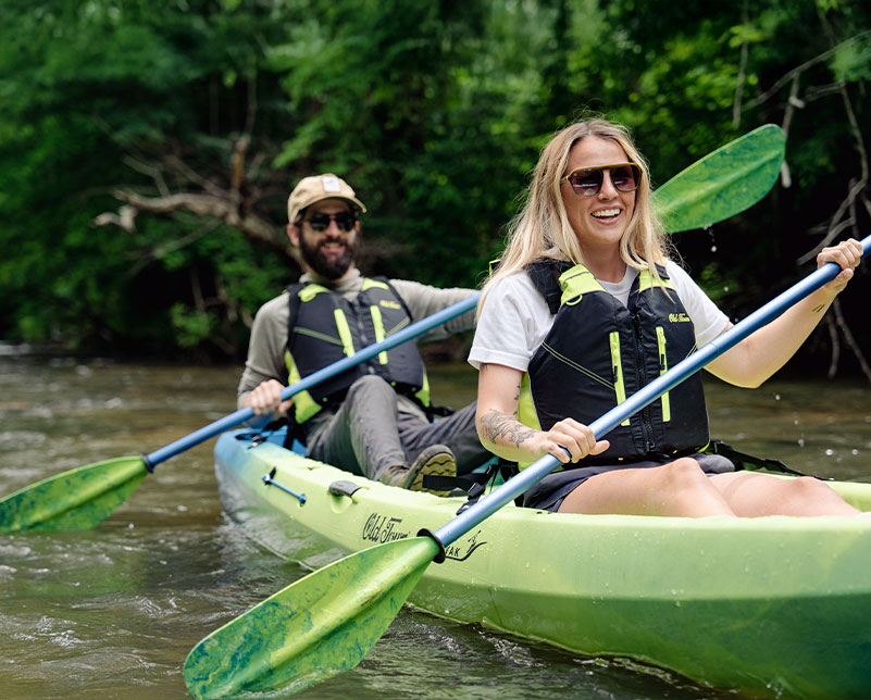 Couple in Old Town Ocean Kayak Malibu Two kayak paddling with Carlisle Magic paddles