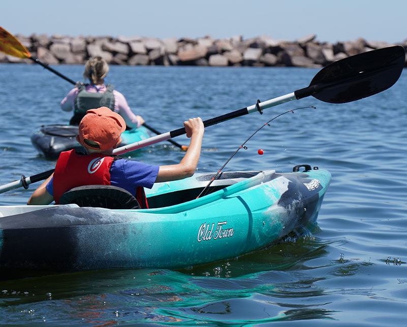 Kid in Old Town Vapor kayak with Carlisle Day Tripper 2 piece paddle